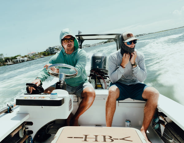 Image of two men in sunglasses on a boat as part of the 'We Care About Your Eyes' Section